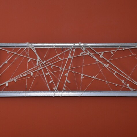 "Hugging You" 2015. 36" x 11" x 1". Natural wool on reclaimed window frame.