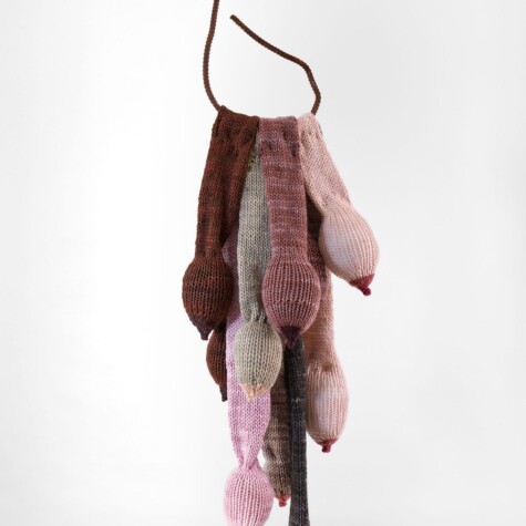"Free to Hang." 2020. Hand knit breast forms mounted on rebar. 50" x 10" x 8"